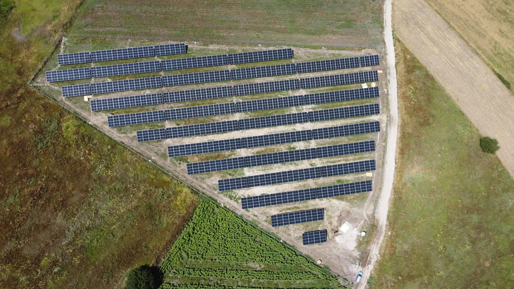 Aerial view of a solar site beside an access road